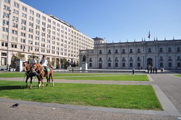 The Palacio de La Moneda, the Chilean government seat in Santiago, with mounted Carabineros on the square