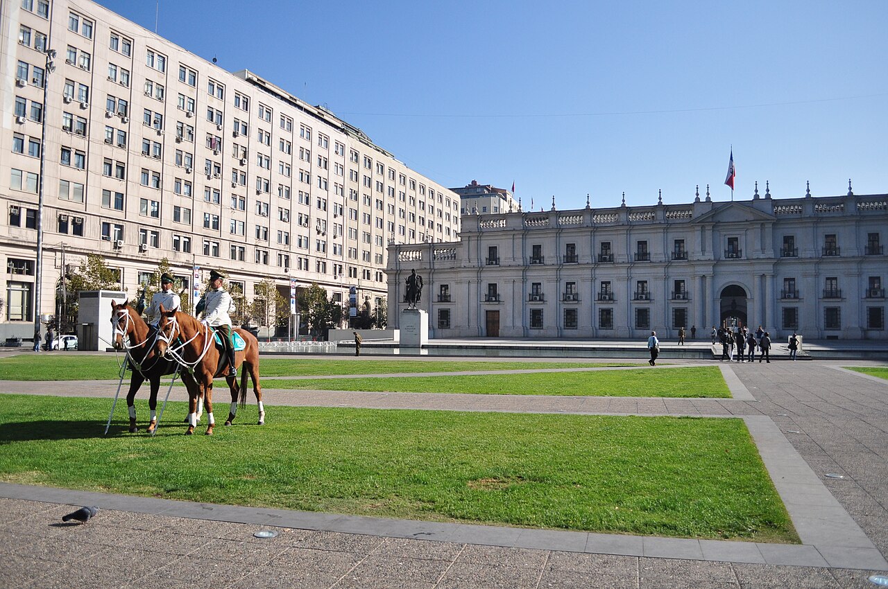 The Palacio de La Moneda, the Chilean government seat in Santiago, with mounted Carabineros on the square