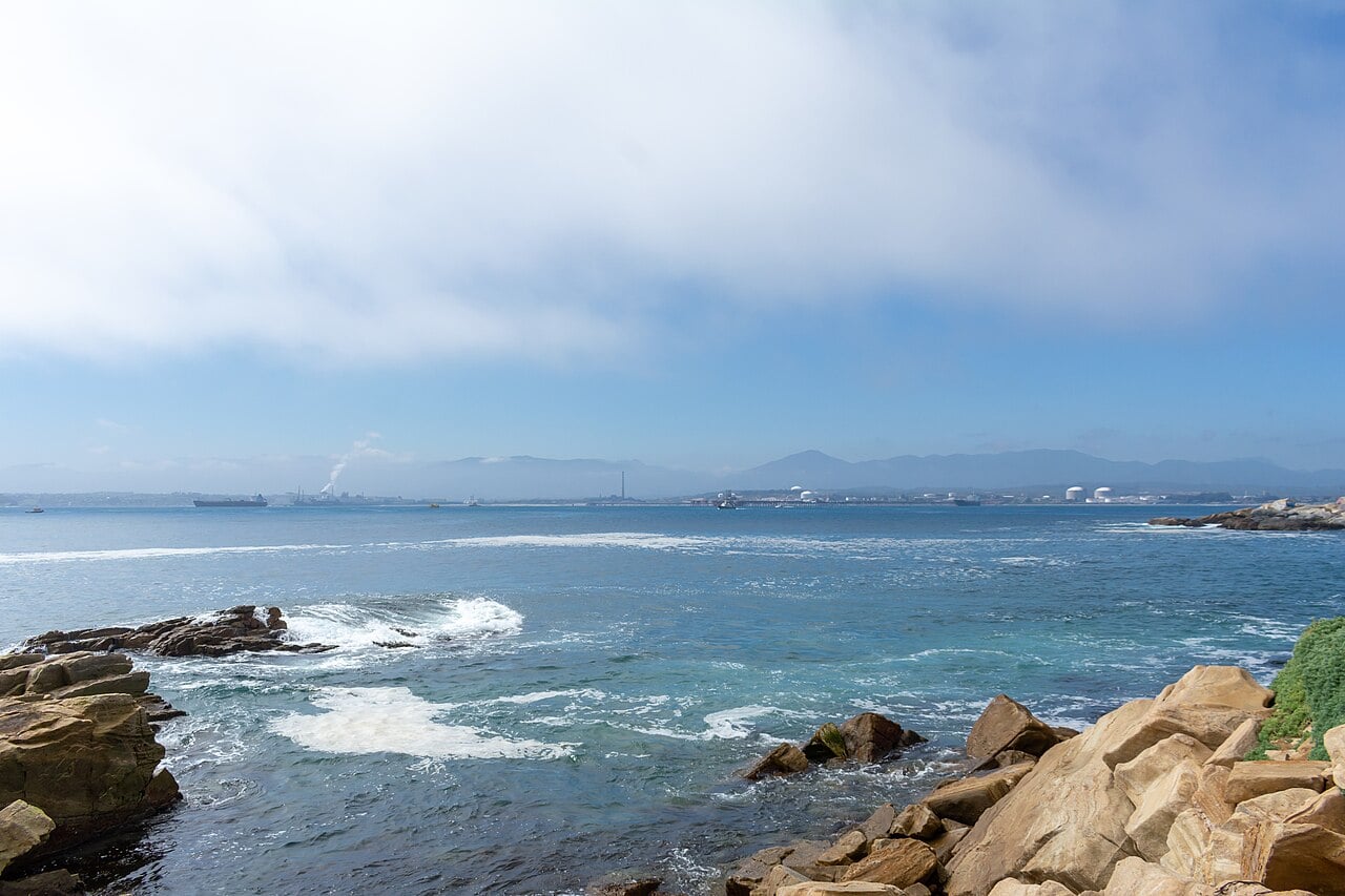 Quintero Bay on Chile's central coast, with fuel tanks and an industrial smokestack on the far shore