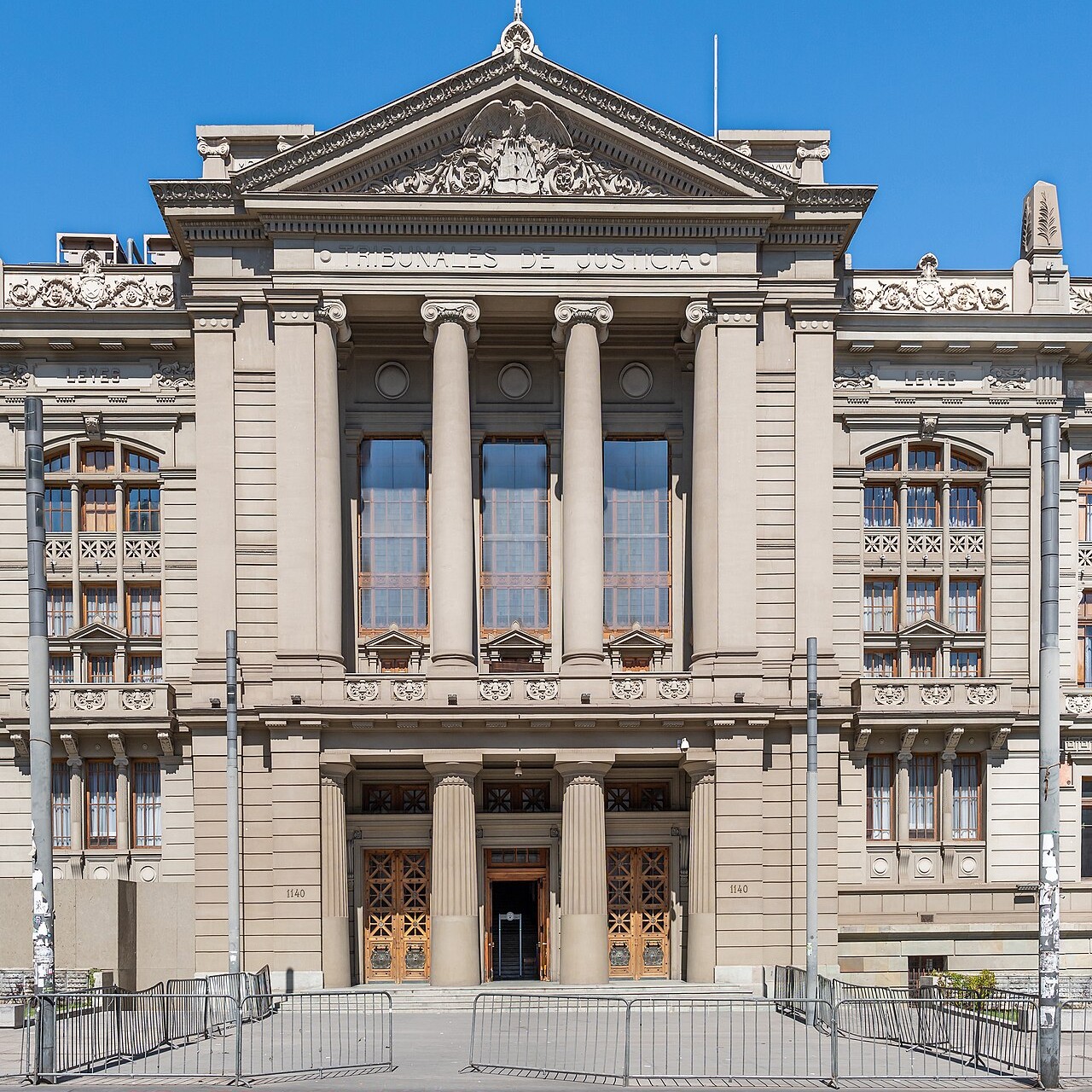 The main entrance of the Palace of Courts in Santiago, Chile, under a clear blue sky
