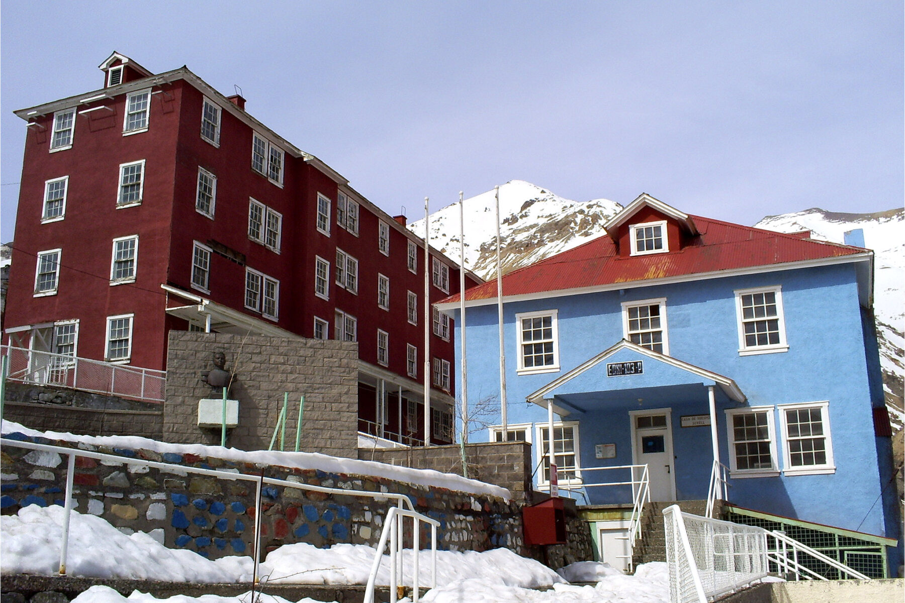Buildings of the Sewell mining camp surrounded by snow in the Chilean Andes
