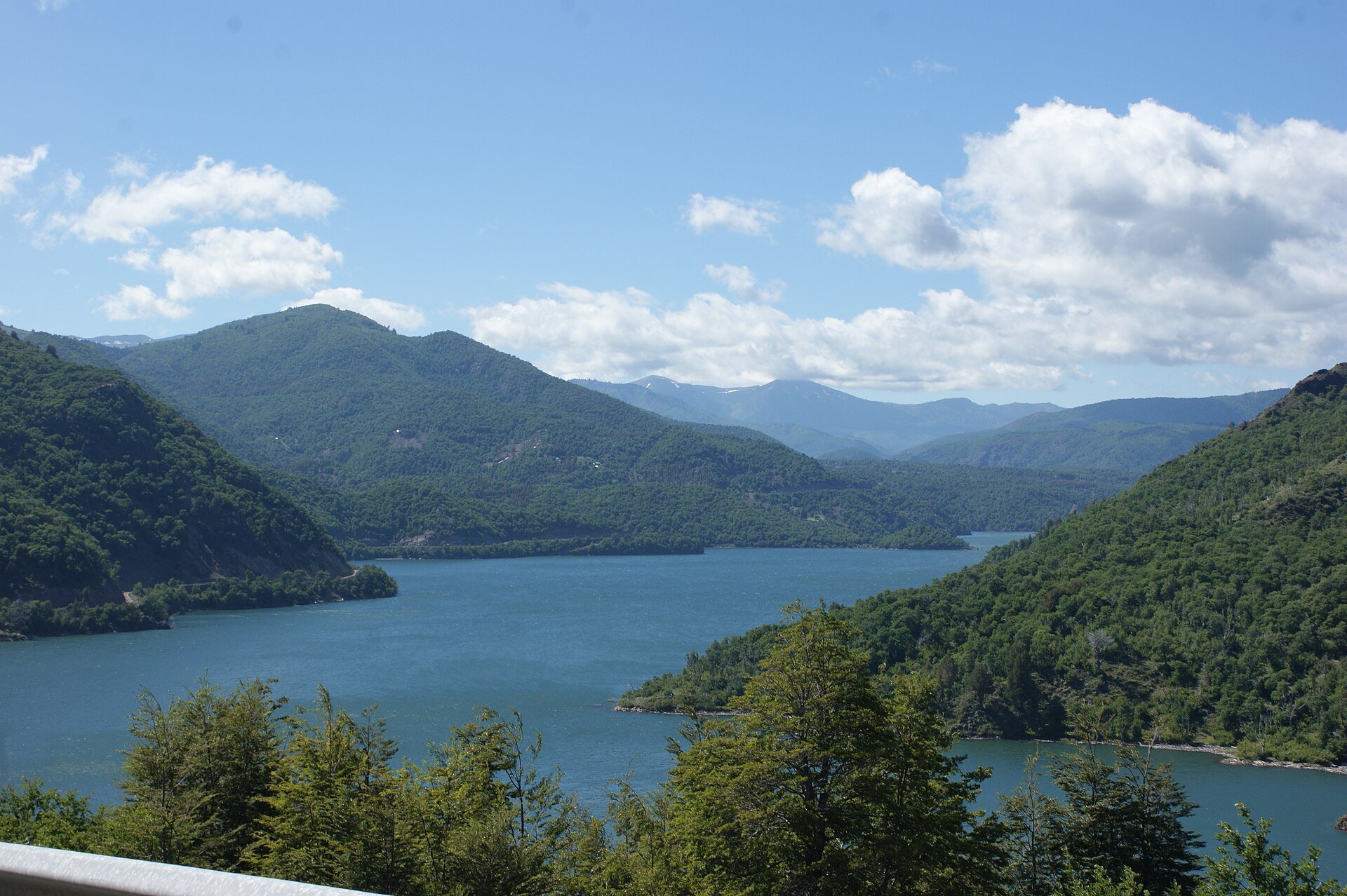 Ralco reservoir in the Alto Biobio area of Chile, surrounded by forested mountains