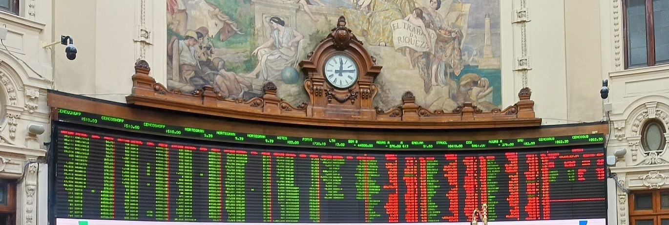 The electronic trading board and clock in the main hall of the Bolsa de Comercio de Santiago in Chile