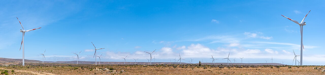 Wind turbines spread across dry hills at the Canela II wind farm in Chile