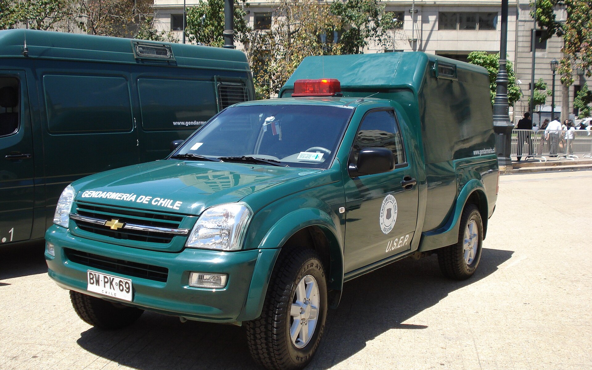 A green Gendarmeria de Chile pickup of the special penitentiary services unit parked on a square in Santiago