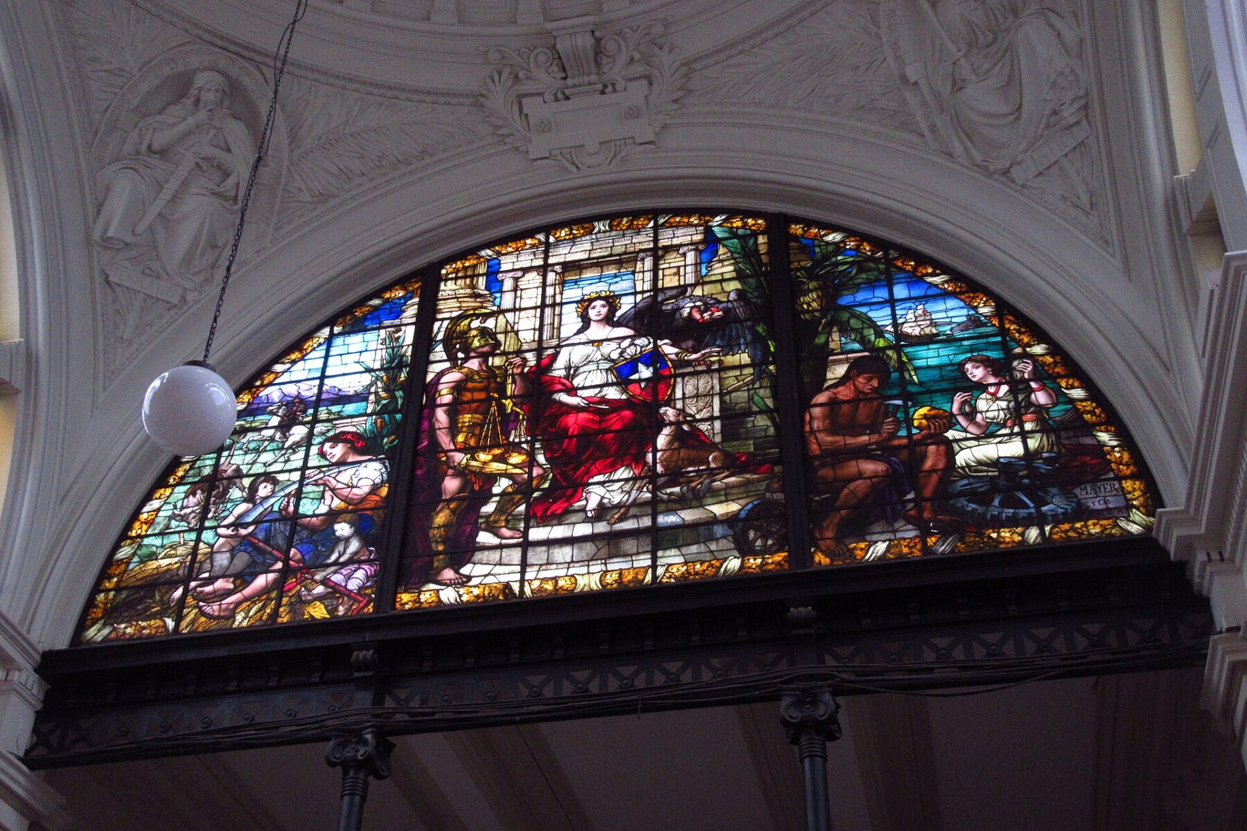 A stained-glass window of Lady Justice with scales and the Chilean shield inside the Palace of Courts in Santiago, Chile