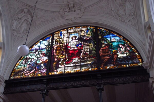 A stained-glass window of Lady Justice with scales and the Chilean shield inside the Palace of Courts in Santiago, Chile