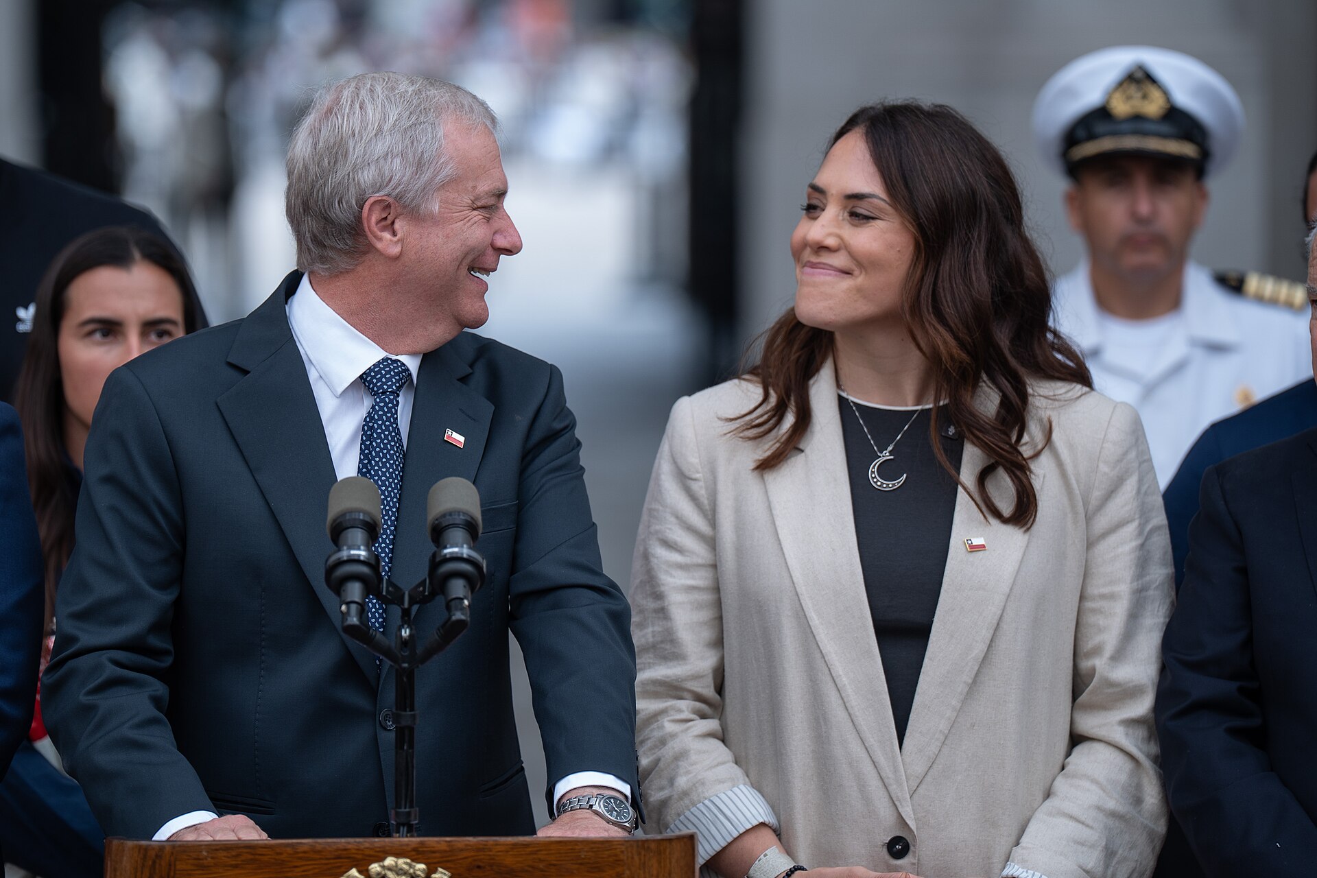 President José Antonio Kast speaking at a podium beside Minister Natalia Duco in Santiago, Chile