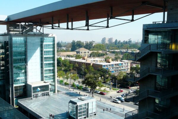 The plaza and glass towers of the Centro de Justicia de Santiago, the court complex in Chile's capital, under a clear sky