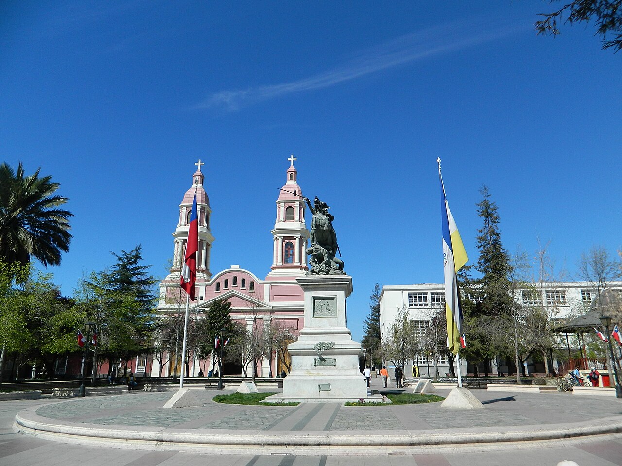 Plaza de Los Héroes in Rancagua, Chile, with the pink cathedral and the equestrian statue of Bernardo O'Higgins