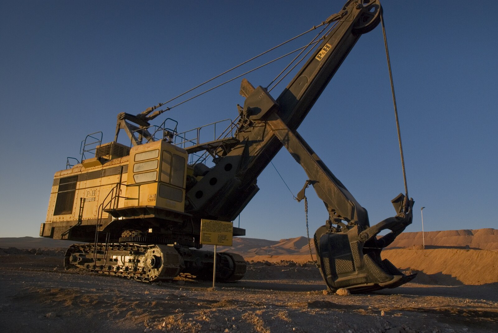 Yellow electric mining shovel at the Mantos Blancos copper mine in the Antofagasta region of Chile at sunset