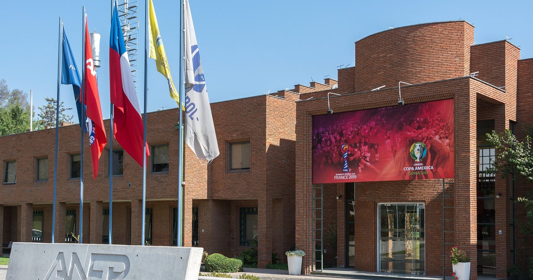 Brick headquarters of the ANFP, Chile's professional football association, in Santiago with its sign and flags in front