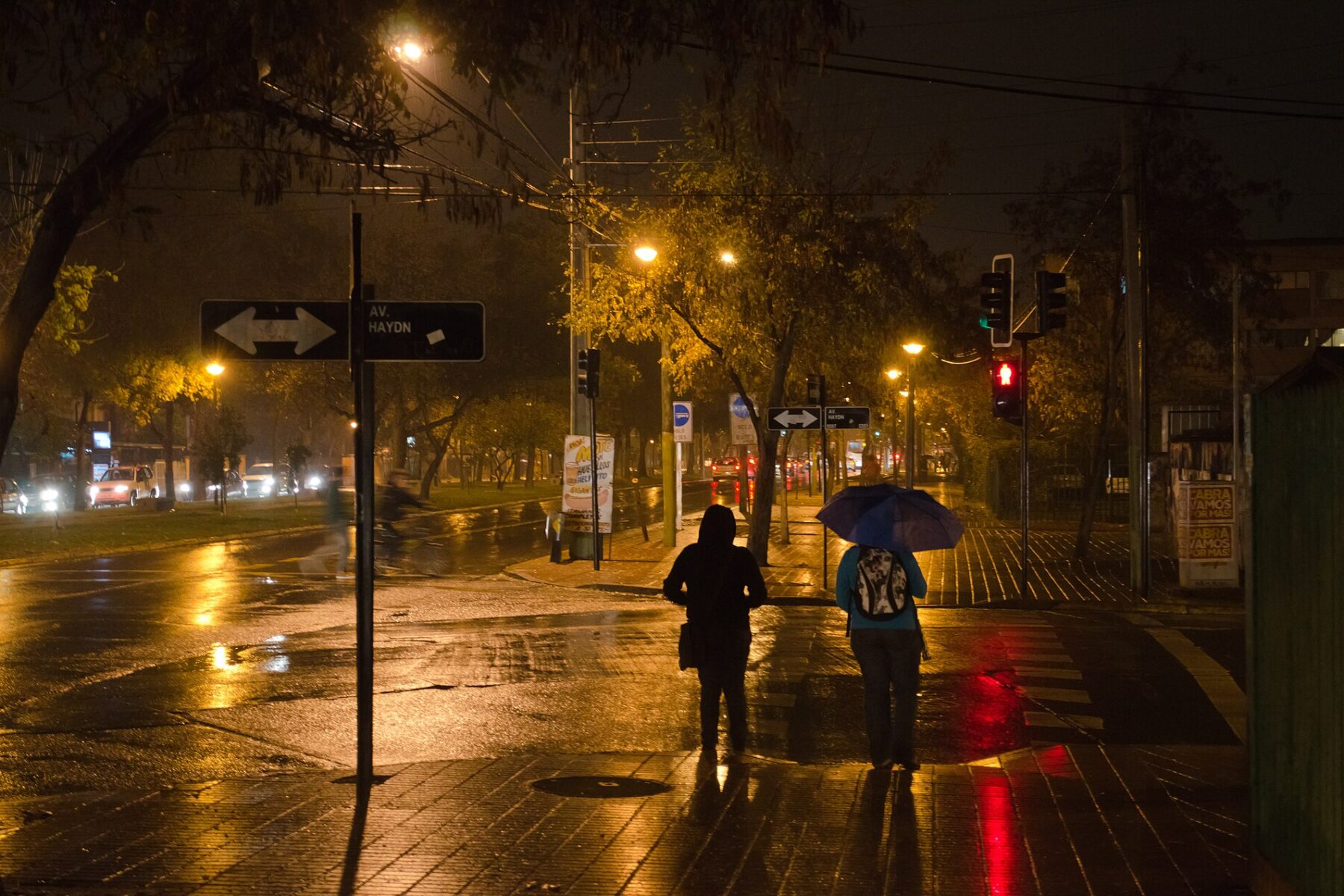 People with an umbrella cross a rain-soaked street in Santiago, Chile (file photo)
