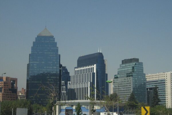 Glass office towers in the financial district of Santiago, Chile, under a clear sky