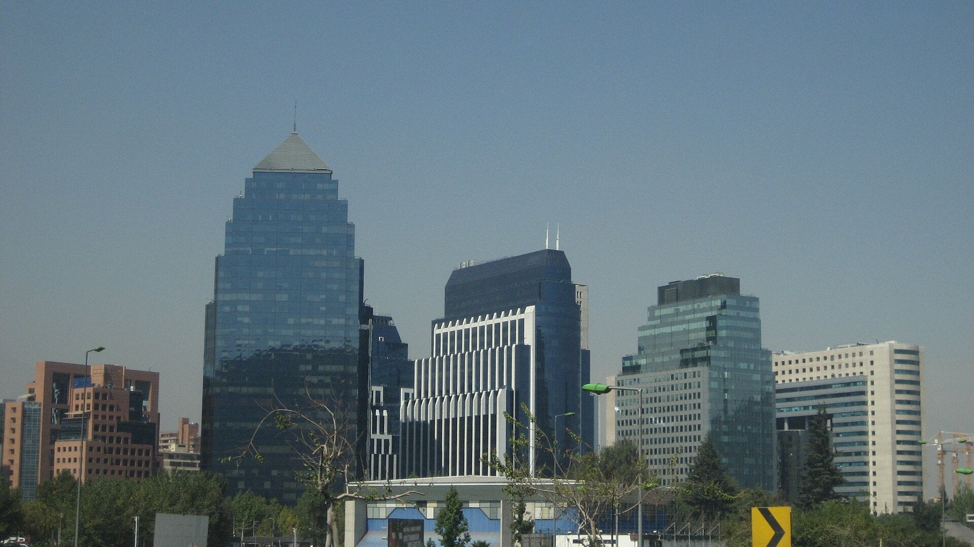 Glass office towers in the financial district of Santiago, Chile, under a clear sky
