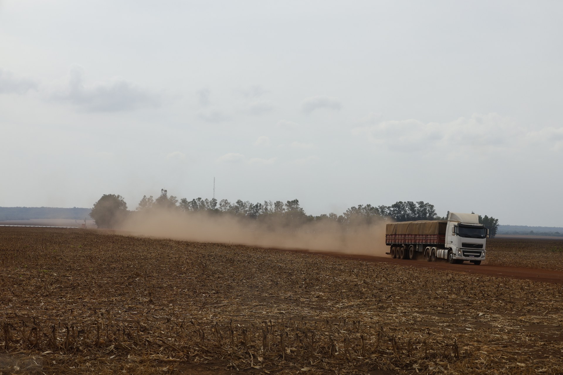 A grain truck raises a cloud of dust on a farm road in Balsas, Maranhão state, Brazil, a soy-growing area