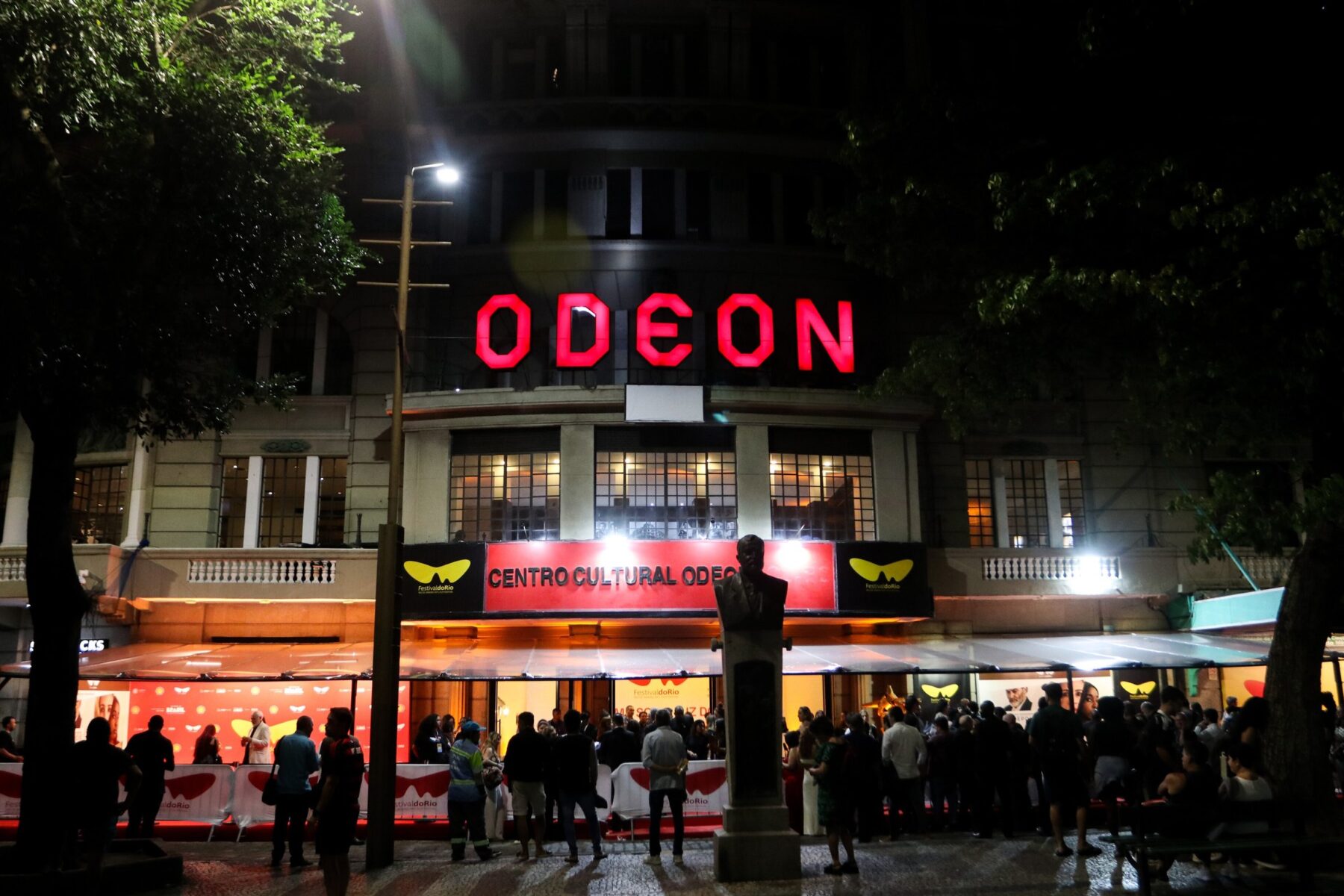 Crowds outside the Cine Odeon in Cinelândia, Rio de Janeiro, lit up at night during the Festival do Rio