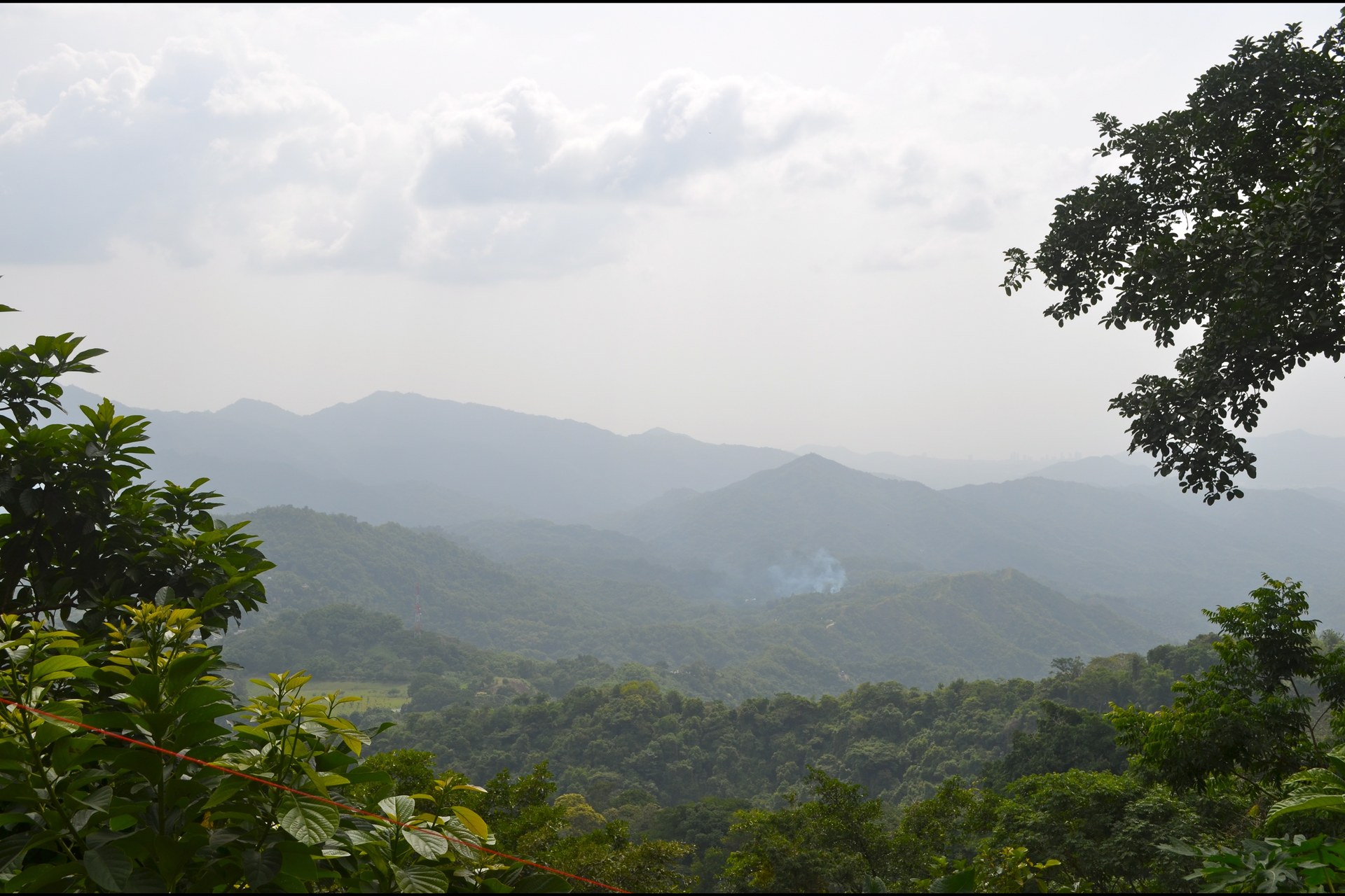 Hazy forested hills and ridges seen from a hill viewpoint in Minca, inland from Santa Marta, Colombia