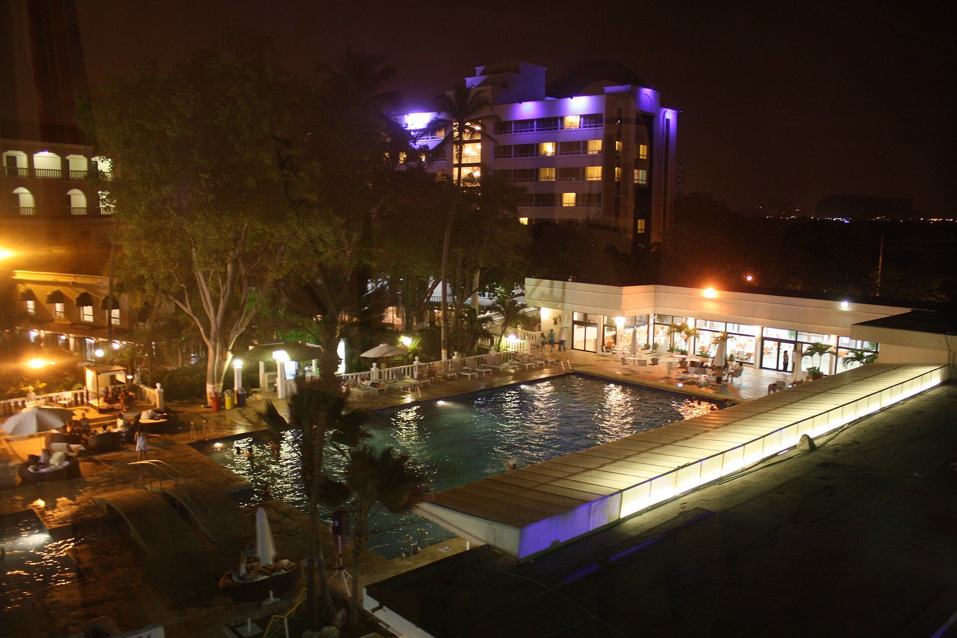 Illuminated hotel swimming pool and tower at night in Cartagena, Colombia