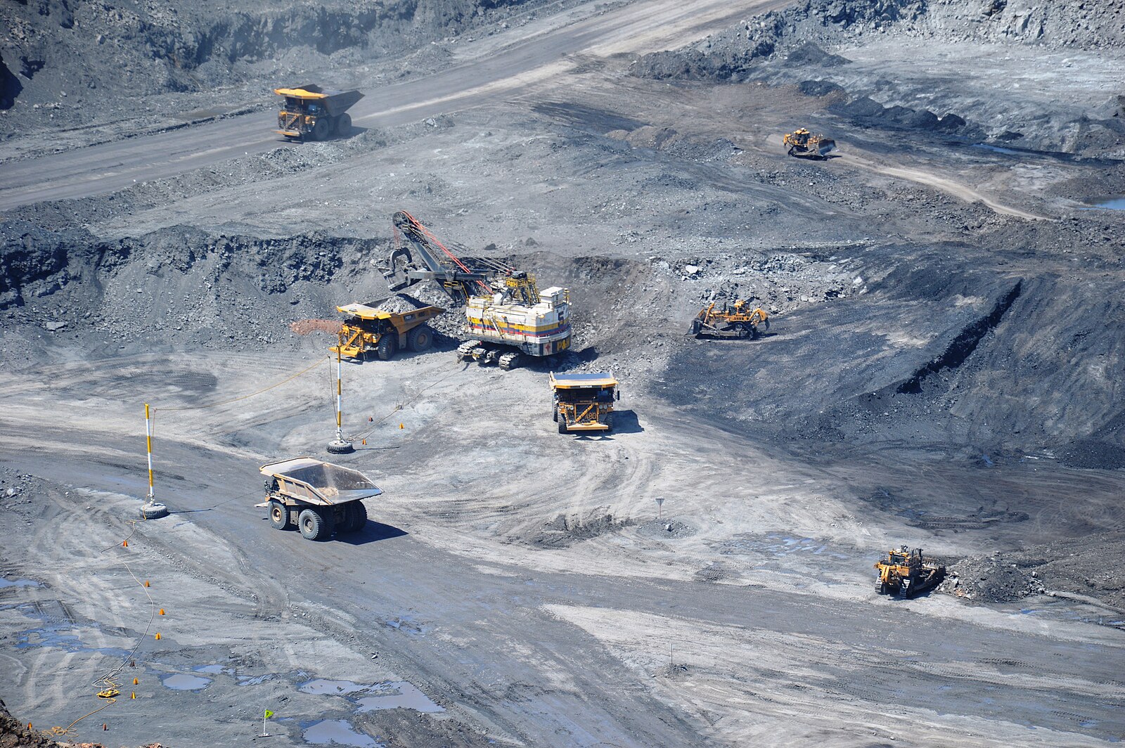 Colombia foreign investment in mining: trucks and an excavator in the Patilla pit at Cerrejón