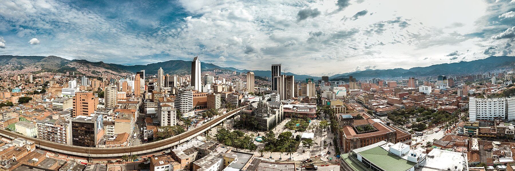 Panoramic view of central Medellin, Colombia, with towers, the cathedral square and mountains behind