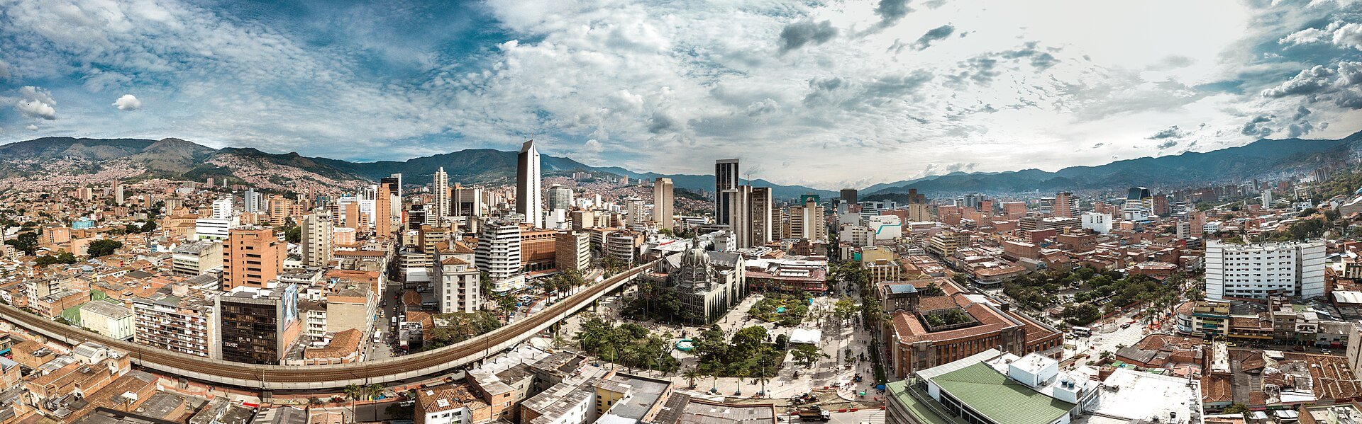 Panoramic view of central Medellin, Colombia, with towers, the cathedral square and mountains behind