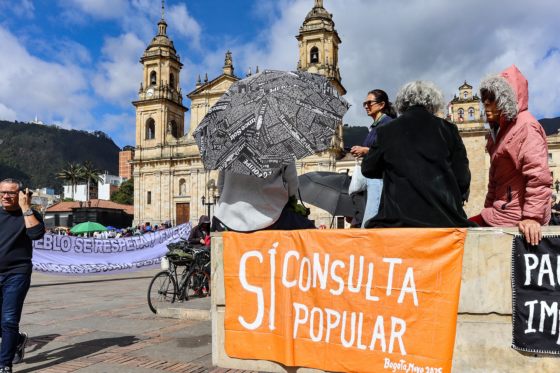 Protesters on Plaza de Bolívar in Bogotá with the cathedral behind them, May 2025