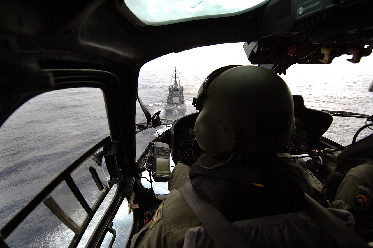 View from a helicopter cockpit of a pilot approaching the Colombian Navy frigate ARC Antioquia at sea