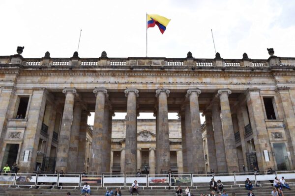 Colombia's flag flies above the stone columns of the Capitolio Nacional on Bogotá's Plaza de Bolívar.