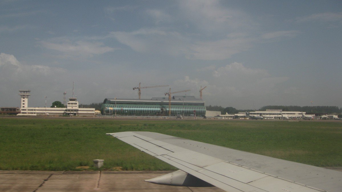 Runway view of Maya-Maya airport in Brazzaville with the control tower and a terminal under construction