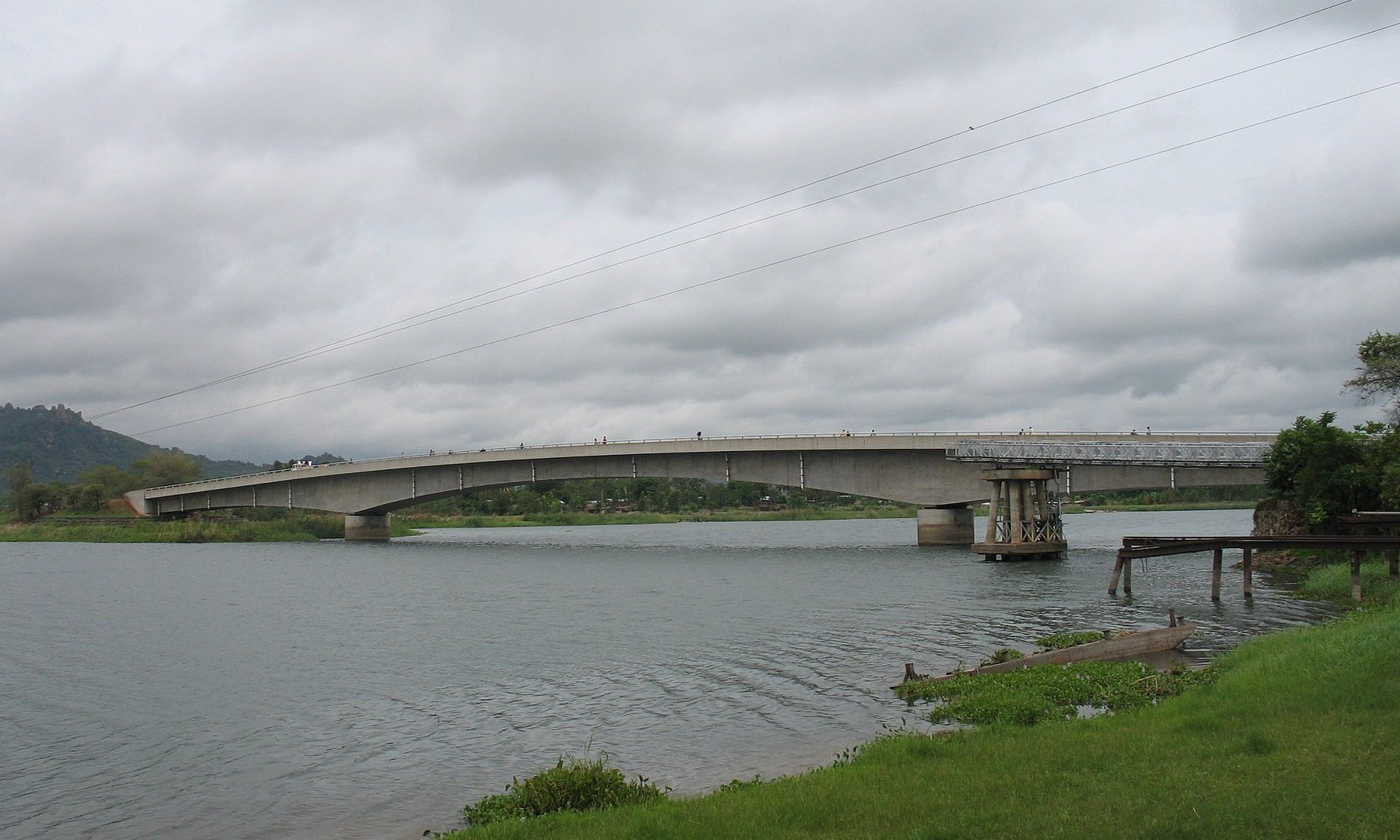 Concrete road bridge over the Shire River at Mangochi in southern Malawi under a cloudy sky