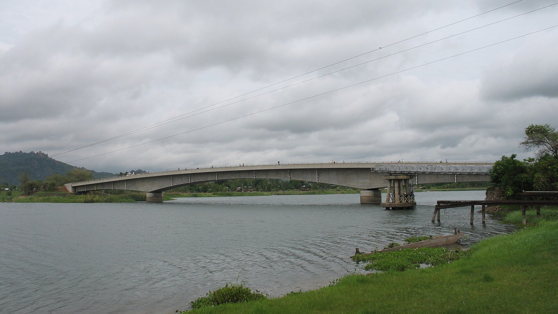 Concrete road bridge over the Shire River at Mangochi in southern Malawi under a cloudy sky