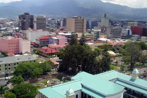 Downtown San Jose Costa Rica with office towers, parks and green roofs below mountains