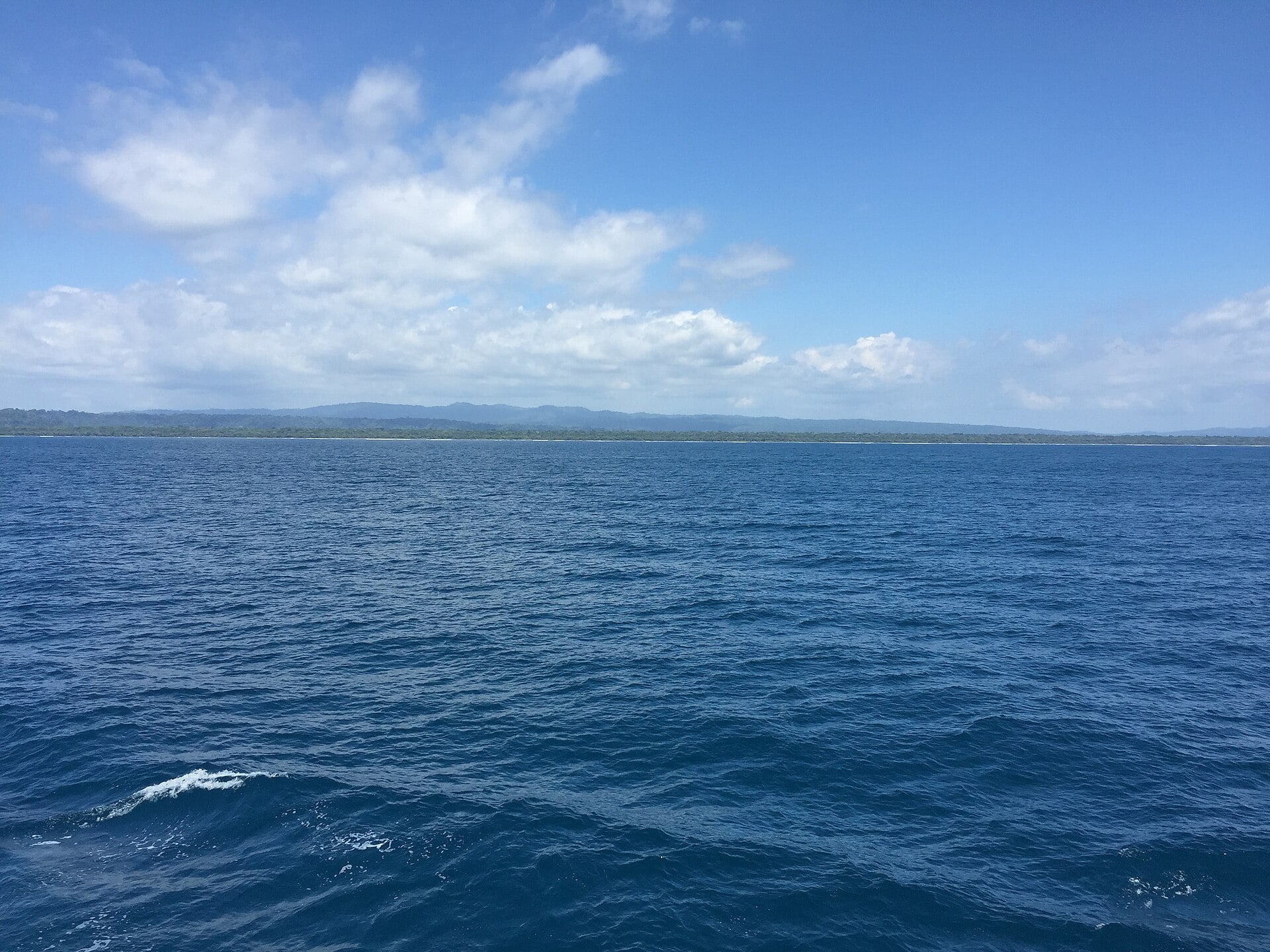 The Pacific Ocean off the Osa Peninsula coast in southern Costa Rica under a partly cloudy sky