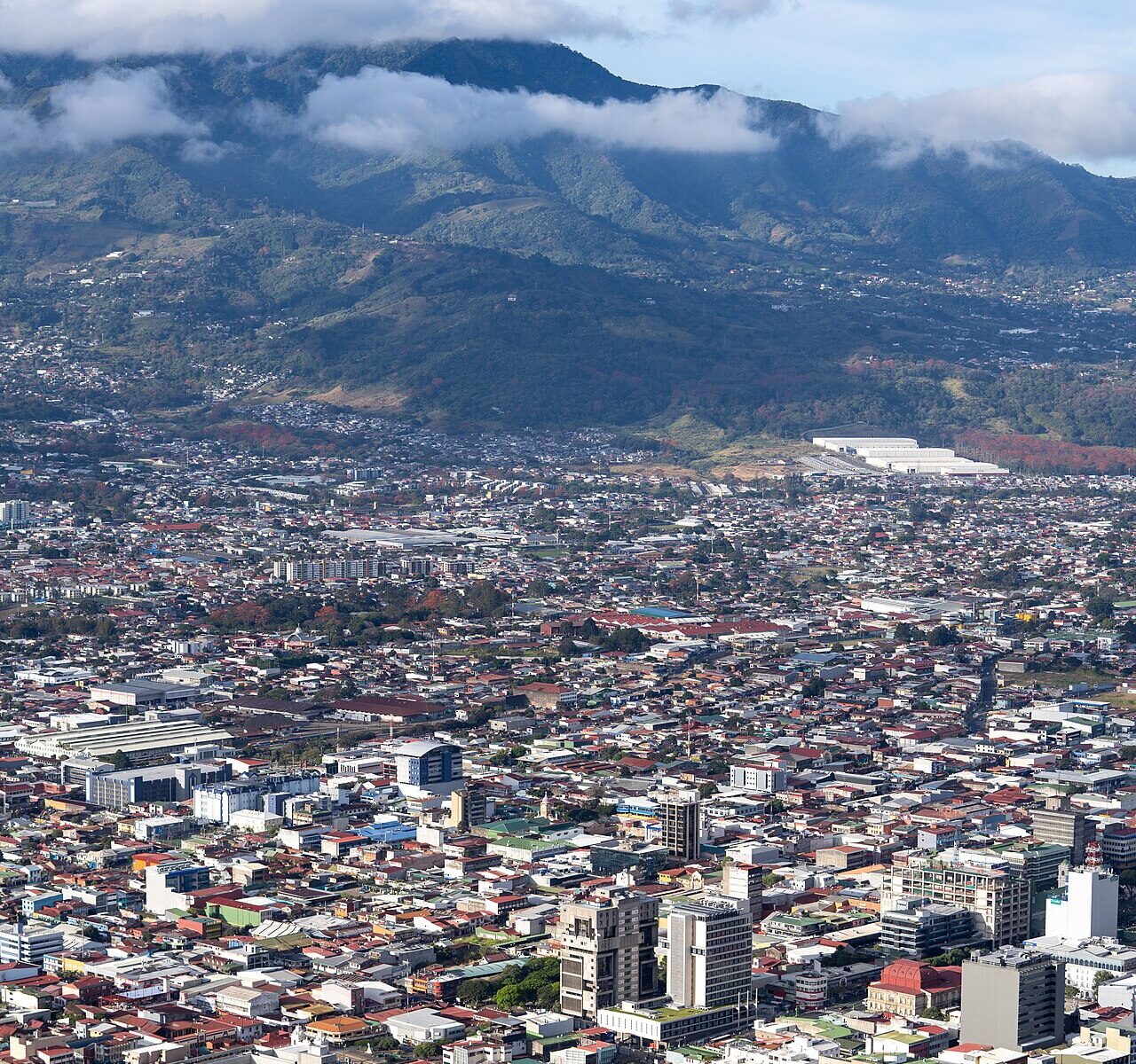 Aerial view of downtown San José, Costa Rica's capital, with the Central Valley mountains behind it.