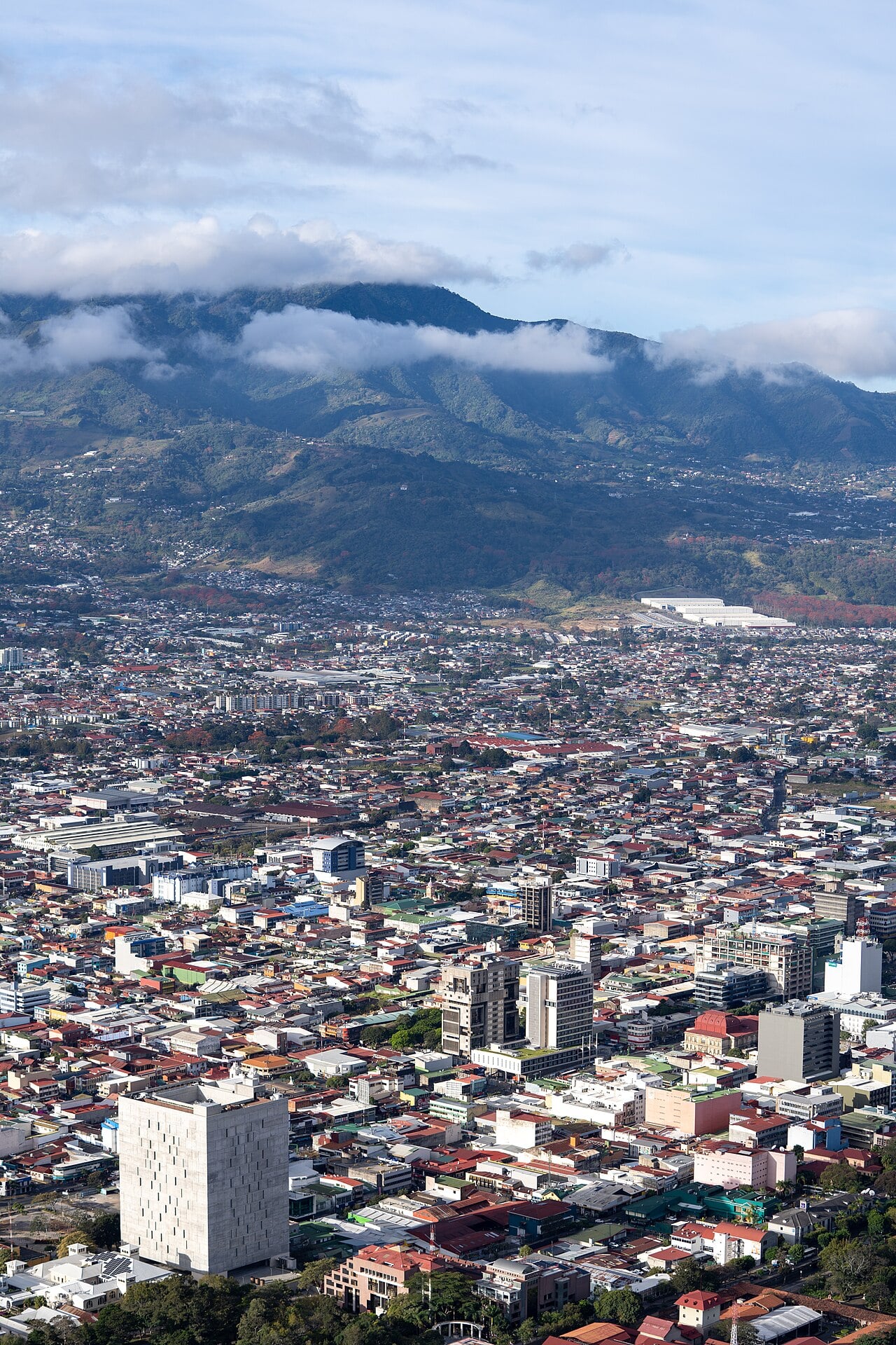 Aerial view of downtown San José, Costa Rica's capital, with the Central Valley mountains behind it.