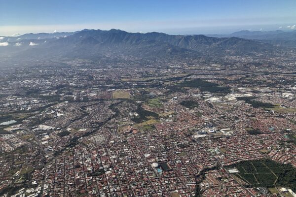 Aerial view of Heredia and the Central Valley of Costa Rica with housing, industrial roofs and mountains in the background