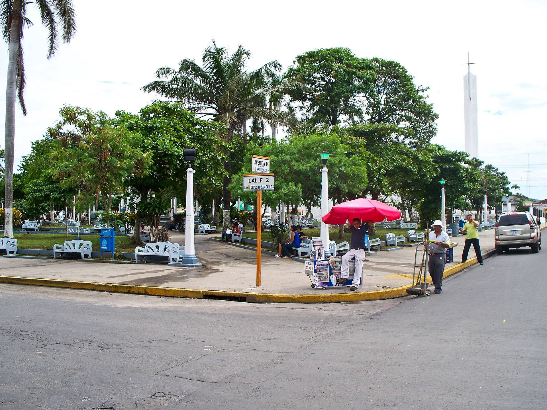 Central park of Liberia, Costa Rica, with benches, palms and a newspaper stand
