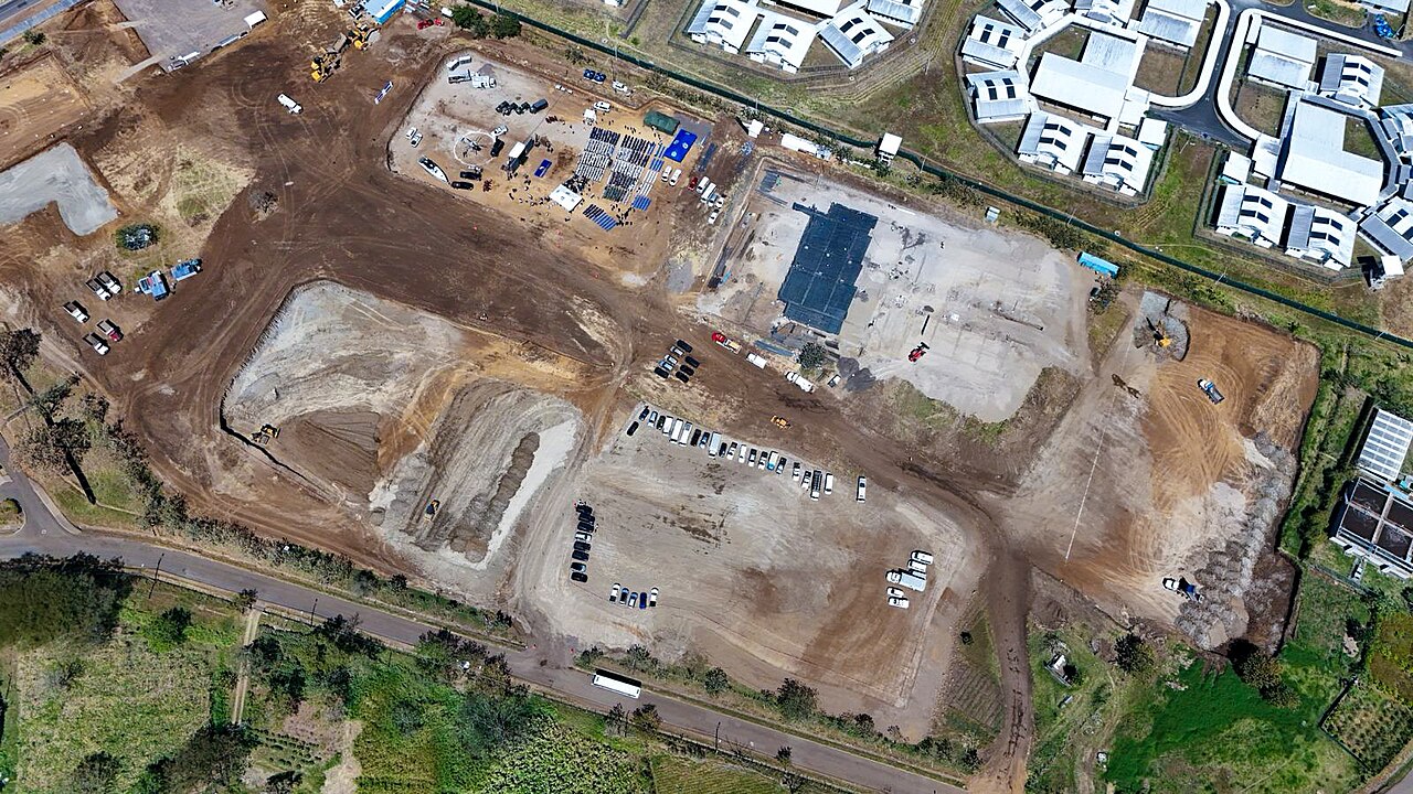 Aerial view of the cleared construction site of the CACCO high-security prison beside existing prison blocks at La Reforma, Alajuela, Costa Rica