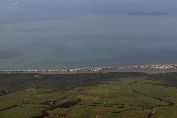 Aerial view of the Puntarenas peninsula and the Gulf of Nicoya on Costa Rica's Pacific coast, with farmland in the foreground