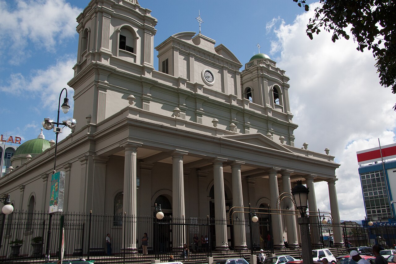 Columned front of the Metropolitan Cathedral in San Jose, Costa Rica, with two bell towers and a clock
