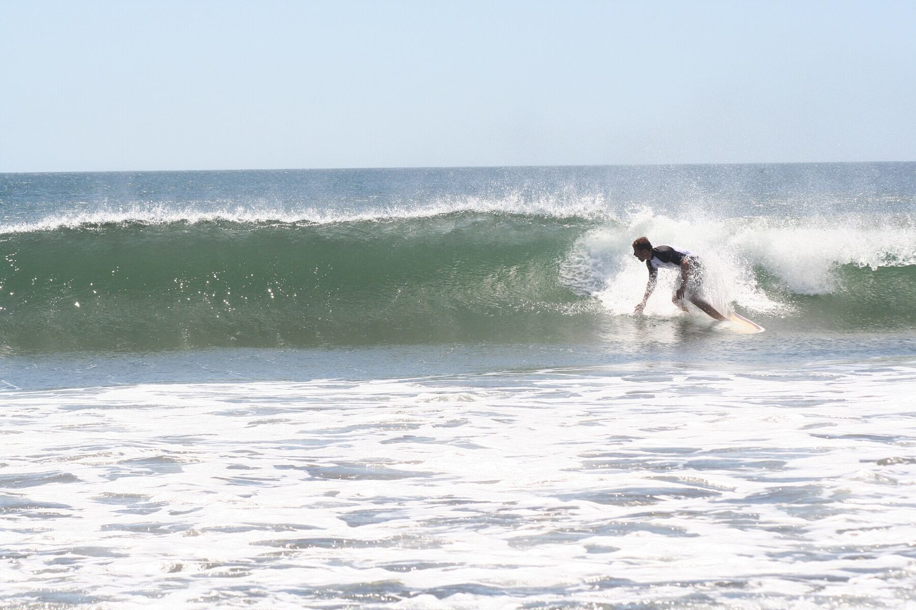 Costa Rica sports: a surfer rides a wave at Witch's Rock in Guanacaste