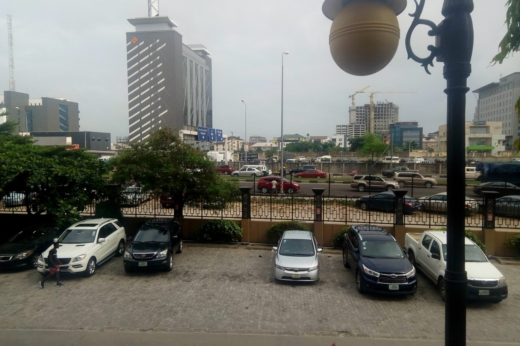 Office towers, a construction crane and traffic on a main road in Victoria Island, Lagos, Nigeria