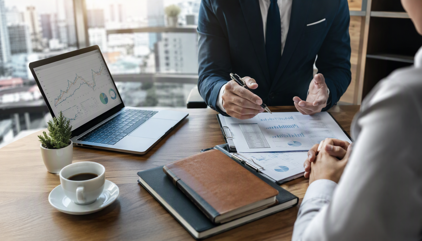 A financial advisor reviewing documents with a client across a desk
