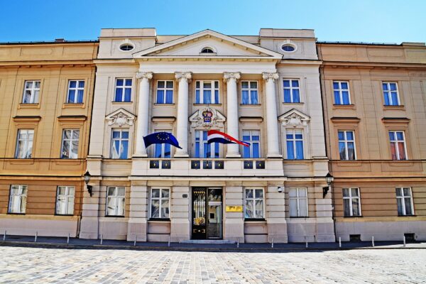 The cream-coloured facade of the Croatian Parliament (Sabor) in Zagreb with the EU and Croatian flags