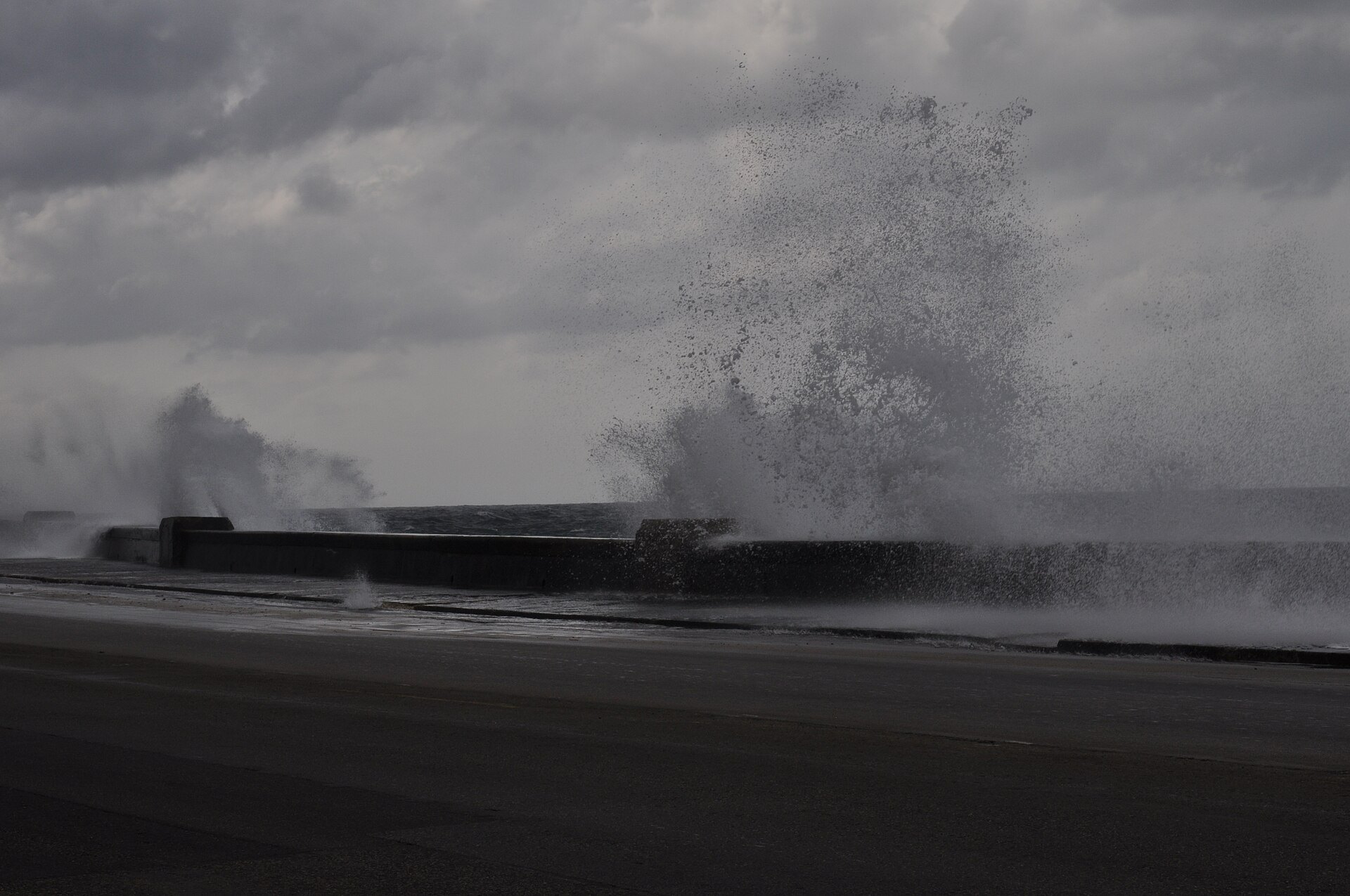Waves break over the sea wall of the Malecón in Havana, Cuba