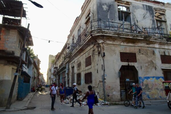 An Old Havana street in daylight with overhead cables and weathered colonial buildings