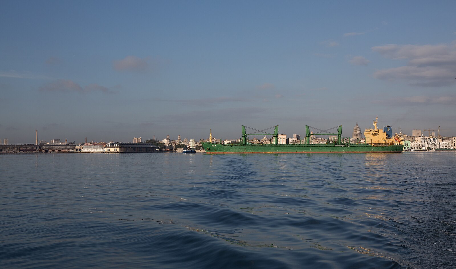 A bulk carrier in Havana harbour with Old Havana and the Capitolio dome behind it, Cuba
