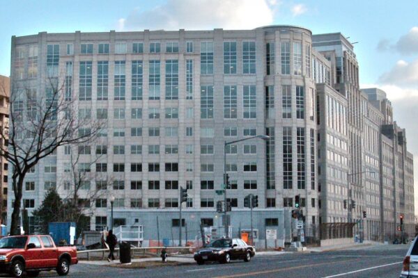 ICE headquarters, a large stone-colored office building on a Washington street corner