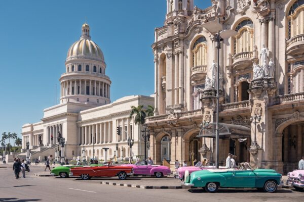 The Capitolio in Havana beside the Gran Teatro, with classic cars parked in the street